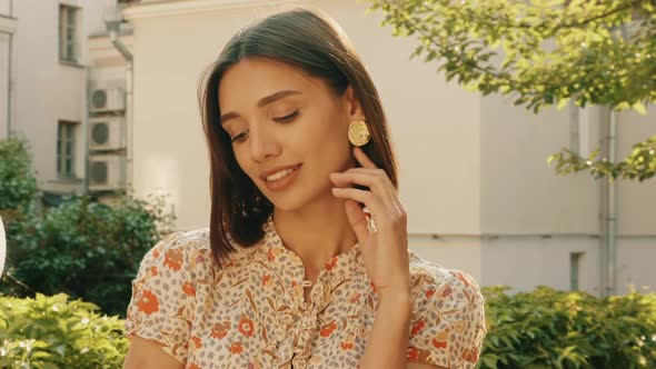 Portrait of young beautiful smiling  woman in trendy summer sundress