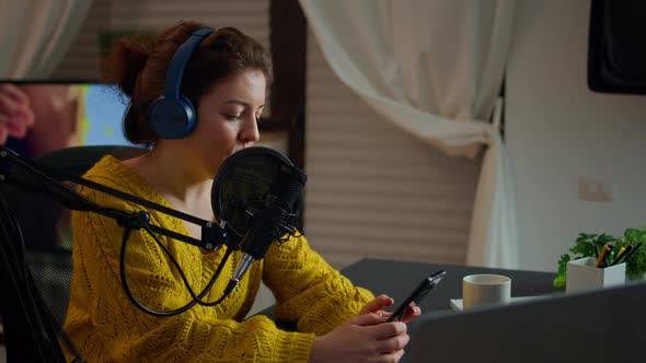 Internet Show Host Answering at Questions of Fans Texting on Phone alt