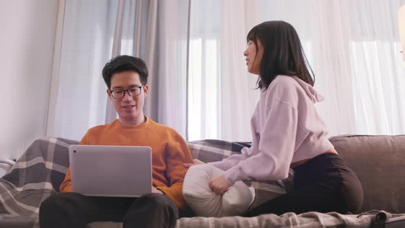 Young Woman Seeking Attention of Her Boyfriend Who Is Working on Laptop alt