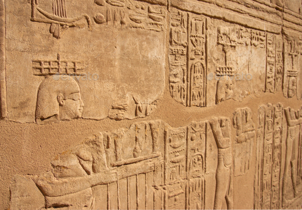 Ancient Egyptian murals hieroglyphs on stone wall in Karnak temple Luxor, Egypt.