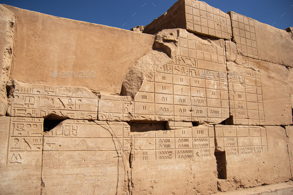 Ancient Egyptian murals hieroglyphs on stone wall in Karnak temple Luxor, Egypt
