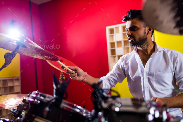 italian artist musician playing drumms during online concert at studio