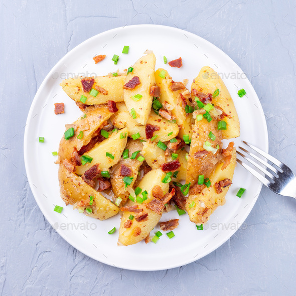 Bacon and onion potato salad with apple cider vinegar and mustard, on plate, square format