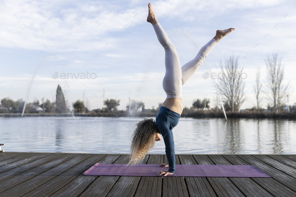 yogi woman practicing yoga concept, standing in Adho Mukha