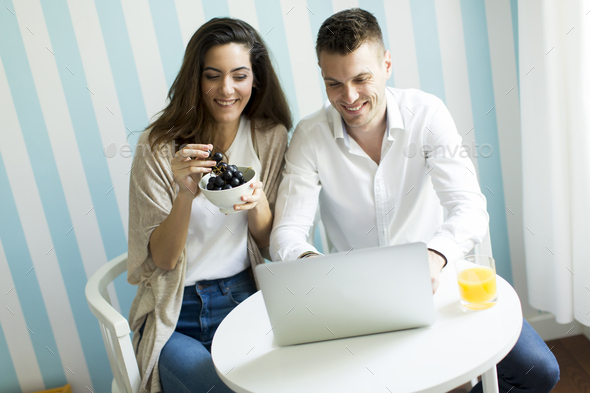 Couple at home websurfing on internet - Stock Photo - Images