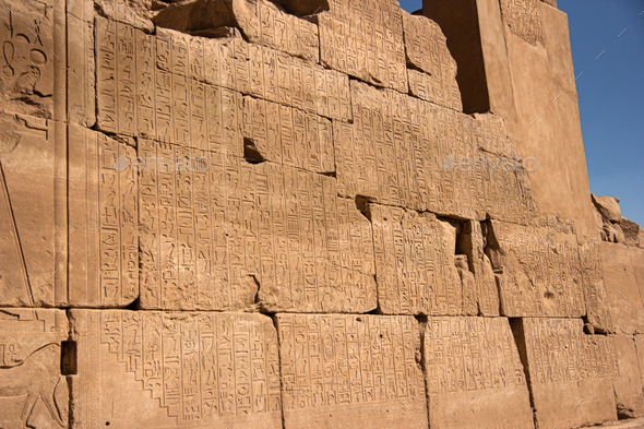 Ancient Egyptian murals hieroglyphs on stone wall in Karnak temple Luxor, Egypt.