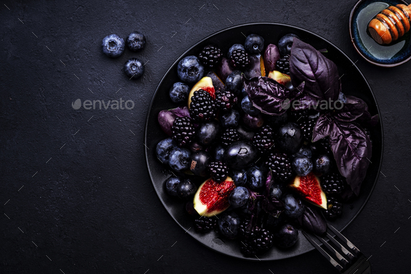 Summer blue and black berries fruit vegan salad: blueberries, blackberries, grapes, figs