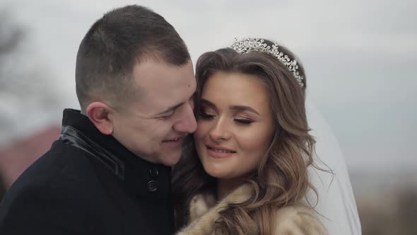 Newlyweds. Face Portrait Shot of Lovely Young Caucasian Groom and Bride alt