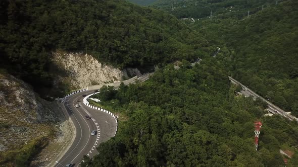Flying Over the Mountains, Along Which the Road Goes with Cars alt