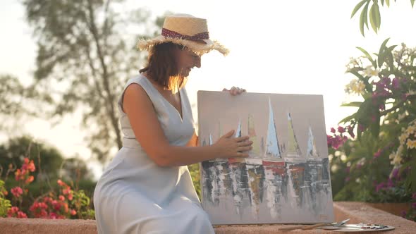 Proud Confident Beautiful Woman Stroking Picture of Sailboats on Sea Smiling Looking at Camera alt
