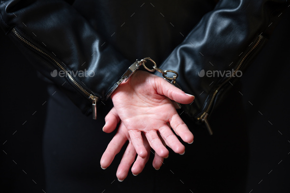 Arrest, protection from crime and law violation. Handcuff criminal woman hands close up.