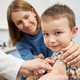 Pediatrician placing medical plaster on child arm after vaccination - PhotoDune Item for Sale