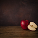 One Whole Apple and One Half Apple on a Wooden Old Surface. Kitchen Table Concept - PhotoDune Item for Sale