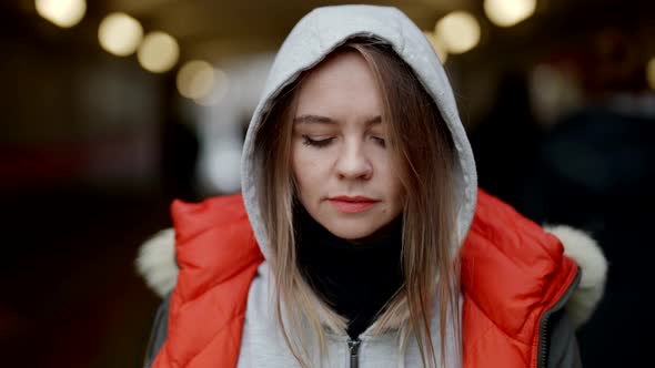 Sad and Angry Woman is Standing on City Street in Center and Looking at Camera Suspiciously alt