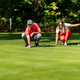 Young couple on a golf course, reading green - PhotoDune Item for Sale