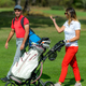 Young couple enjoying a game of golf, walking the fairway on a golf course on a beautiful sunny day - PhotoDune Item for Sale
