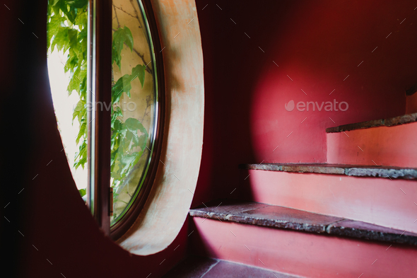 red stairs in a house. window with plants by the stairs. Home, indoors and decoration concept
