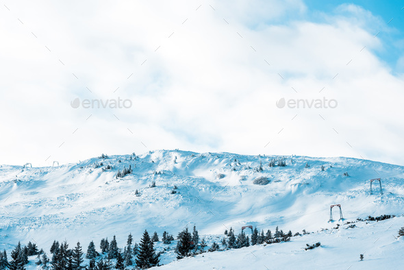 Scenic View Of Snowy Mountain With Pine Trees In White Fluffy Clouds ...