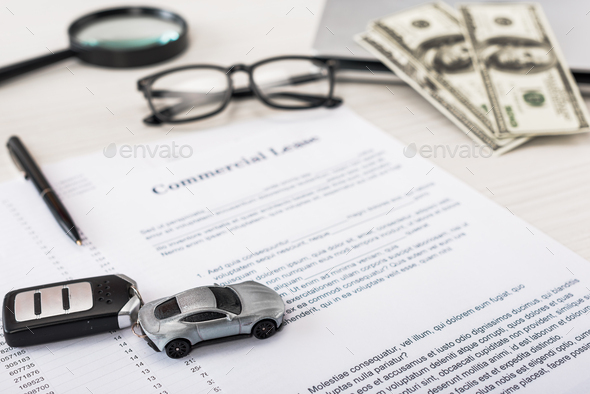 selective focus of toy car near document with commercial lease lettering - Stock Photo - Images