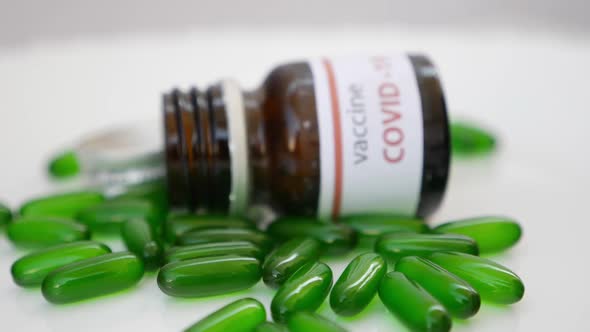 rotating shot covid-19 vaccine tablets, Shot of green tablets with white background