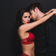 sexy woman in red bra and panties hugging handsome man isolated on black  Stock Photo by LightFieldStudios