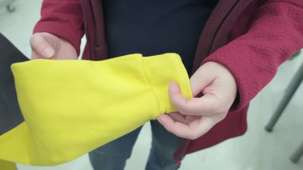 Woman in Store Buys Yellow Gray Hoodie