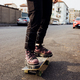Close up nonconformist unrecognizable person riding longboard skateboarding - PhotoDune Item for Sale