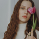 Portrait of a young girl with long hair and a tulip flower. - PhotoDune Item for Sale