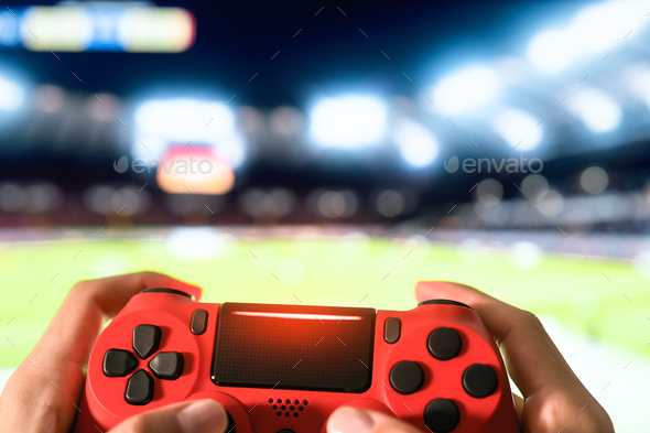 Young man having fun playing online soccer video games