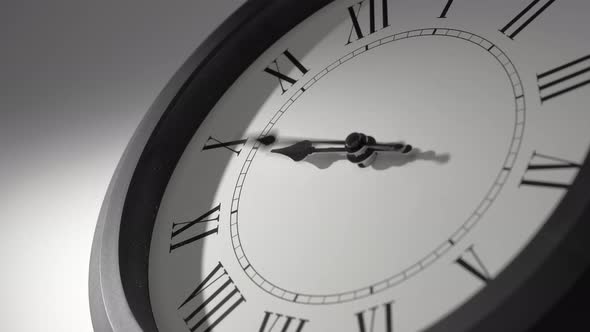 Latin Clock Face in Time Lapse on White Wall