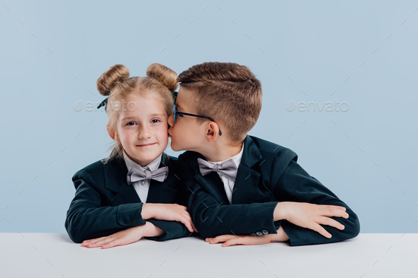 education. little boy kissing little girl on the cheek,
