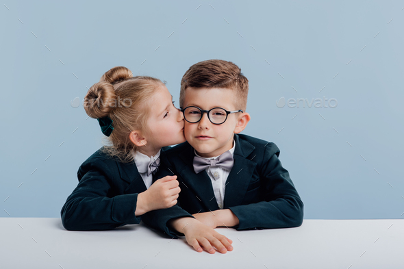 education. little girl kissing little boy on the cheek,