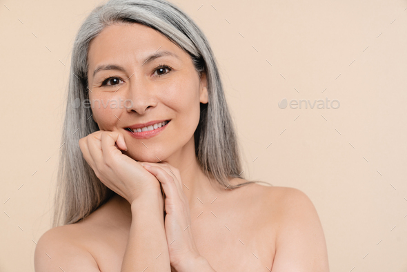Anti-age collagen anti-wrinkle cosmetics beauty products. Woman with grey hair . Aging skin hair