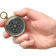 Hand holding traditional magnetic compass - PhotoDune Item for Sale