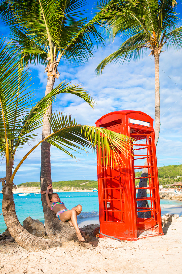 Beautiftul kid near red phone booth in Dickenson's bay Antigua - Stock Photo - Images