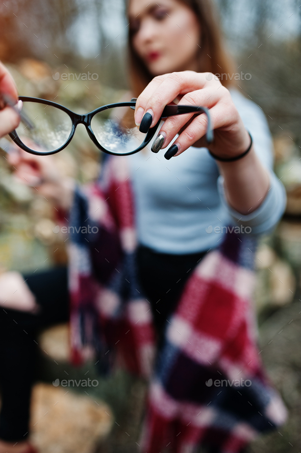 Girl gives her friend glasses, soft focus. Bad eye vision of people.