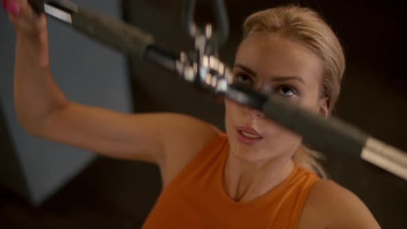 Portrait of Woman Athlete Having Workout in Sport Club. Fit Girl Making Pulldown alt