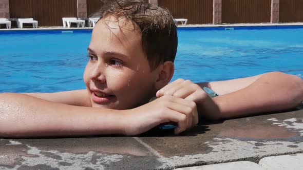 Portrait A Teenage Girl Leans on the Edge of the Pool with Her Hands and Swims Up Close and Talks on alt