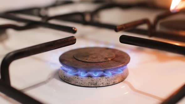 Close Up of Lighting the Gas Burner with a Match at Home