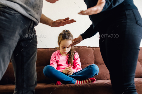 stressed little girl upset tired of parents fight.