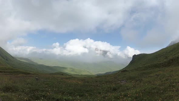 Clouds fill the mountain valley. alt