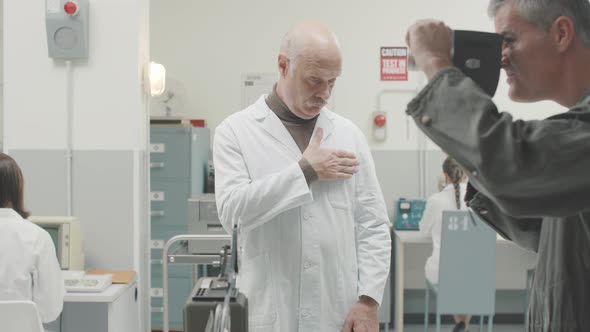 Operator shooting a footage of a scientist expaining his project