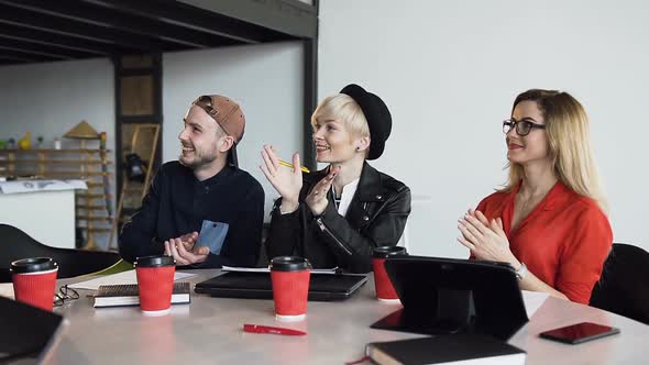 Team of Creative Businesspeople Sitting Around Boardroom Table Applaud Presentation Colleague alt