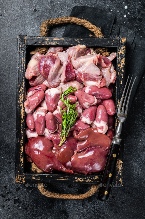 Uncooked Bird offals, raw chicken giblets, gizzards, stomachs, liver