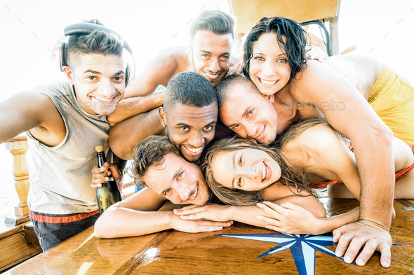 Group of best friends guys and girls taking selfie at sailing boat