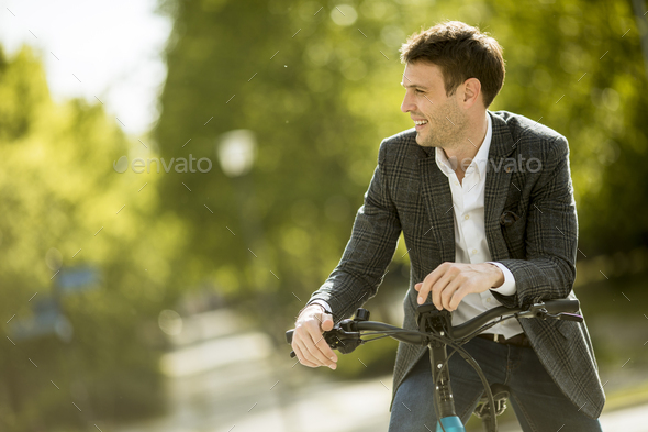 Young businessman on the ebike - Stock Photo - Images