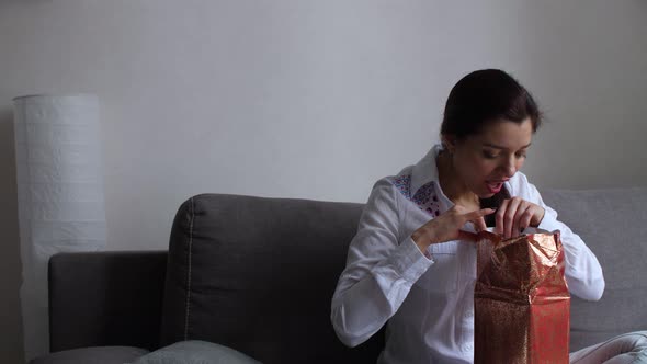 Girl at Home Fiddling with Gifts alt