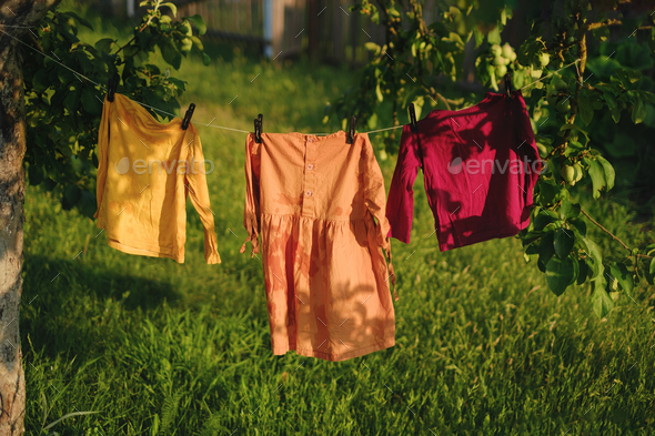 Childrens colored underwear dry on clothesline in garden in nature after laundry