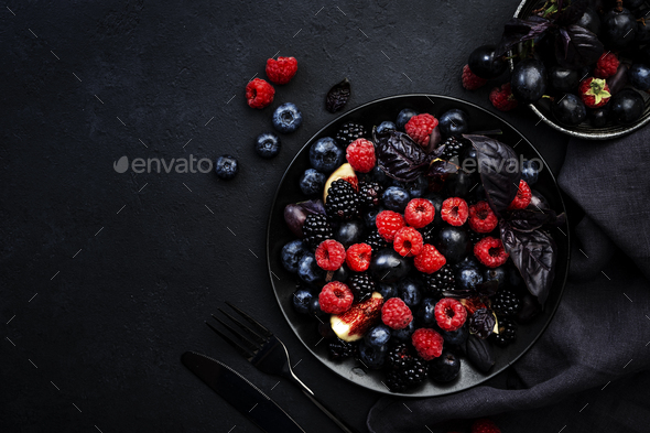 Summer blue and black berries fruit vegan salad: blueberries, blackberries, grapes, figs