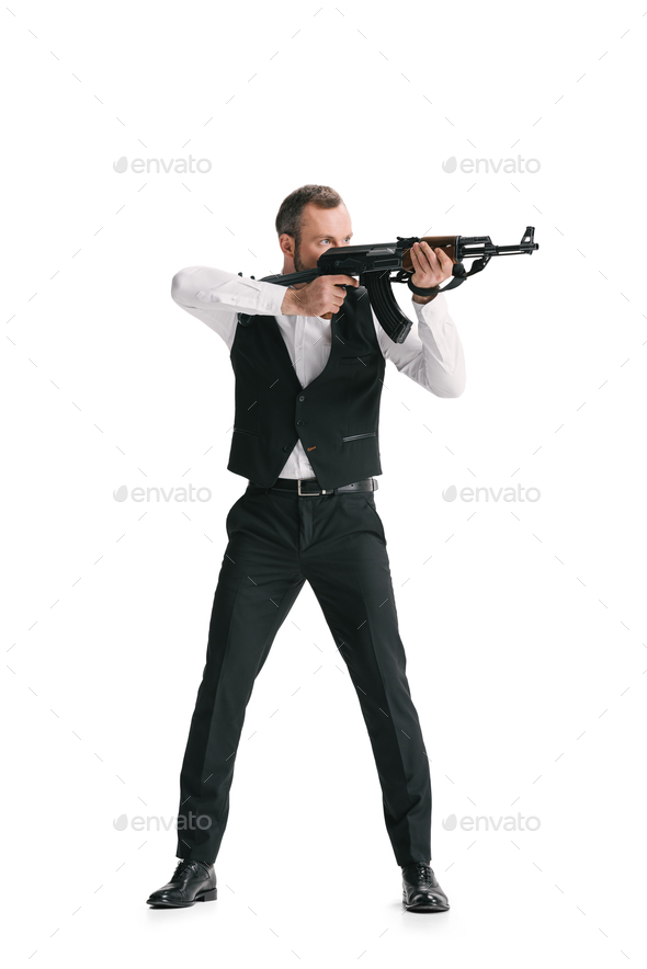 secret agent in stylish suit with rifle isolated on white Stock Photo ...